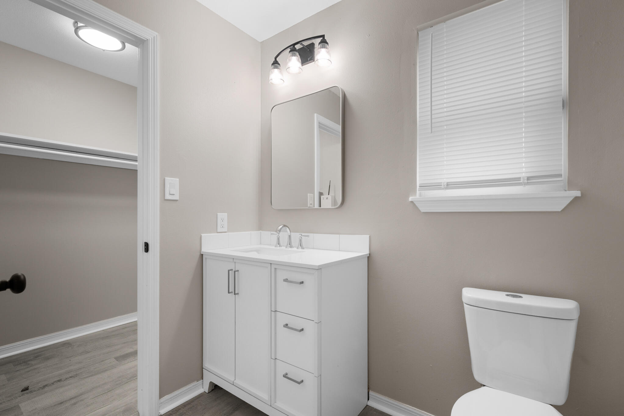 3437 Auburn Road Crestview, FL 32539 - Photo 5 of 26 a bathroom with a toilet sink and mirror