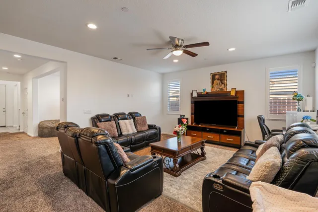 a living room with furniture and a flat screen tv with wooden floor