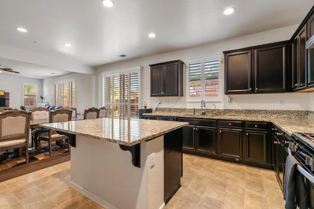 a kitchen with stainless steel appliances granite countertop a sink stove and oven