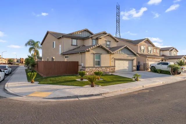 a front view of a house with a garden and plants