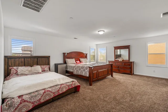 a bedroom with two beds and a window