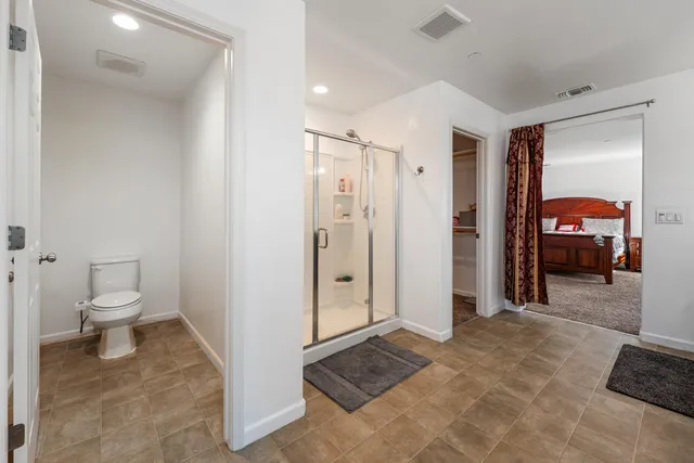 a view of a bathroom with a toilet and a shower