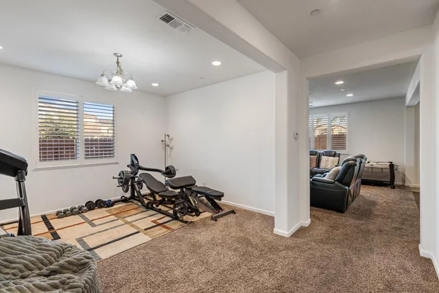 a view of a workspace with furniture and a window