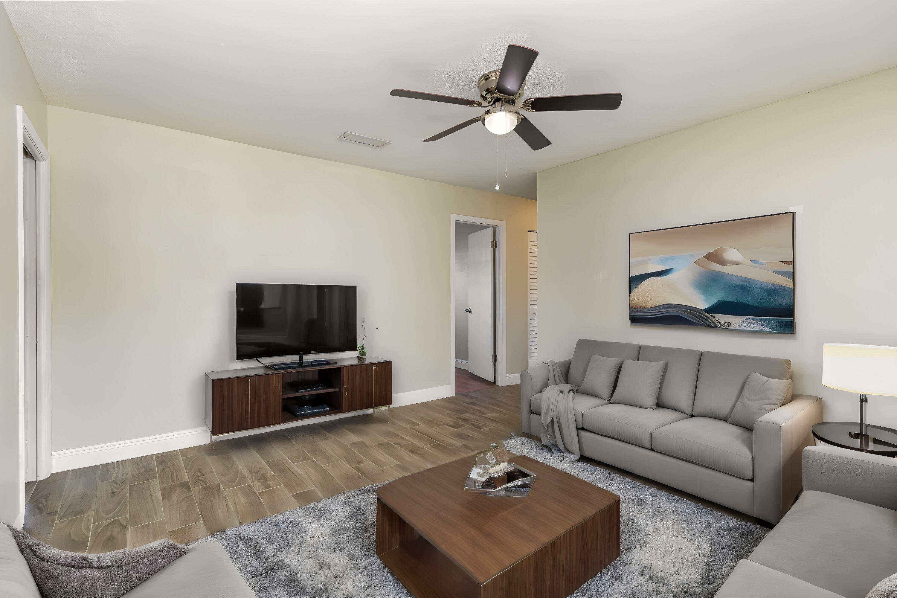 1294 Cimarron Circle Northeast Palm Bay, FL 32905 - Photo 12 of 45 a living room with furniture and a flat screen tv