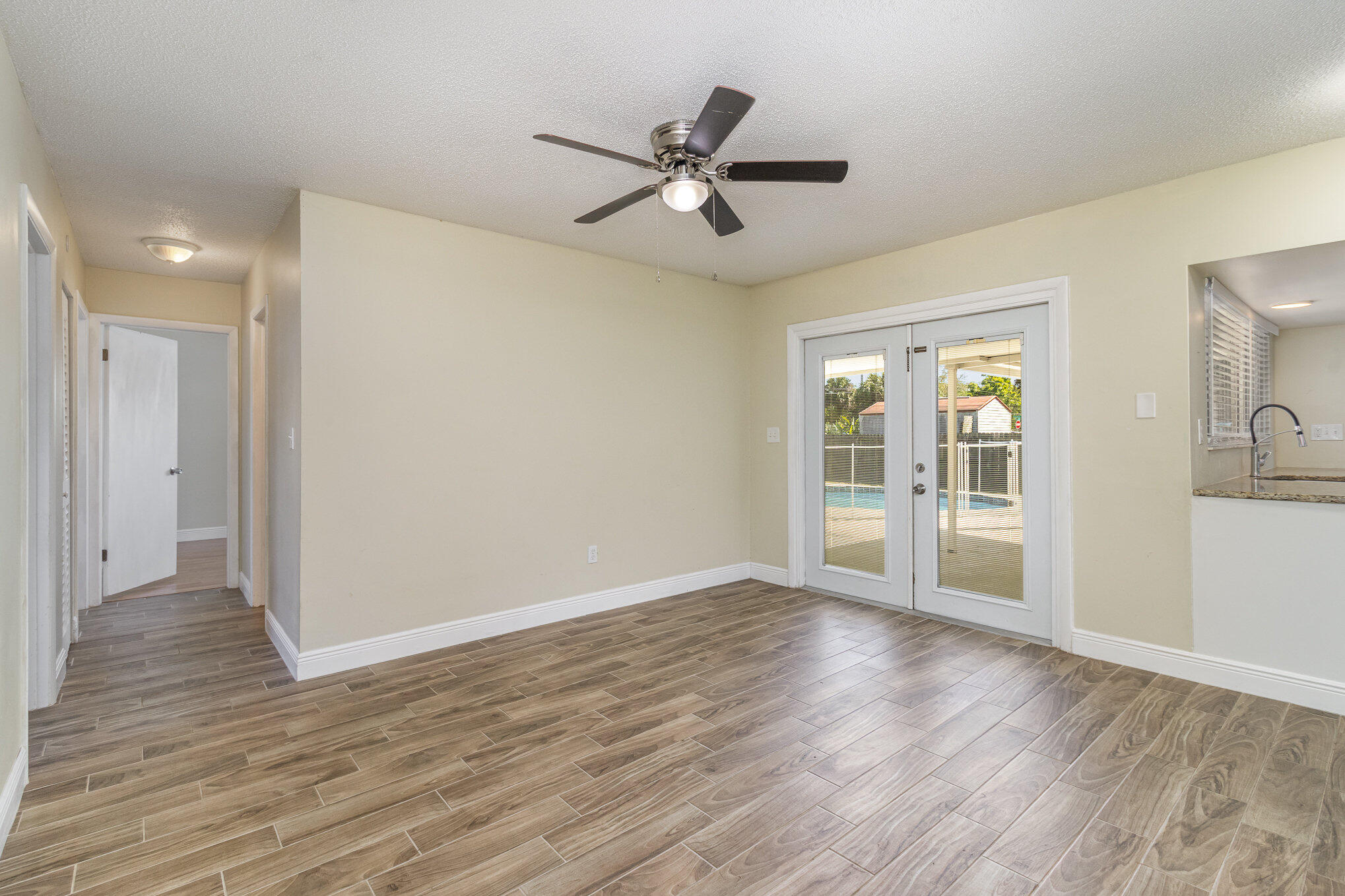 1294 Cimarron Circle Northeast Palm Bay, FL 32905 - Photo 13 of 45 a view of an empty room with wooden floor and a window