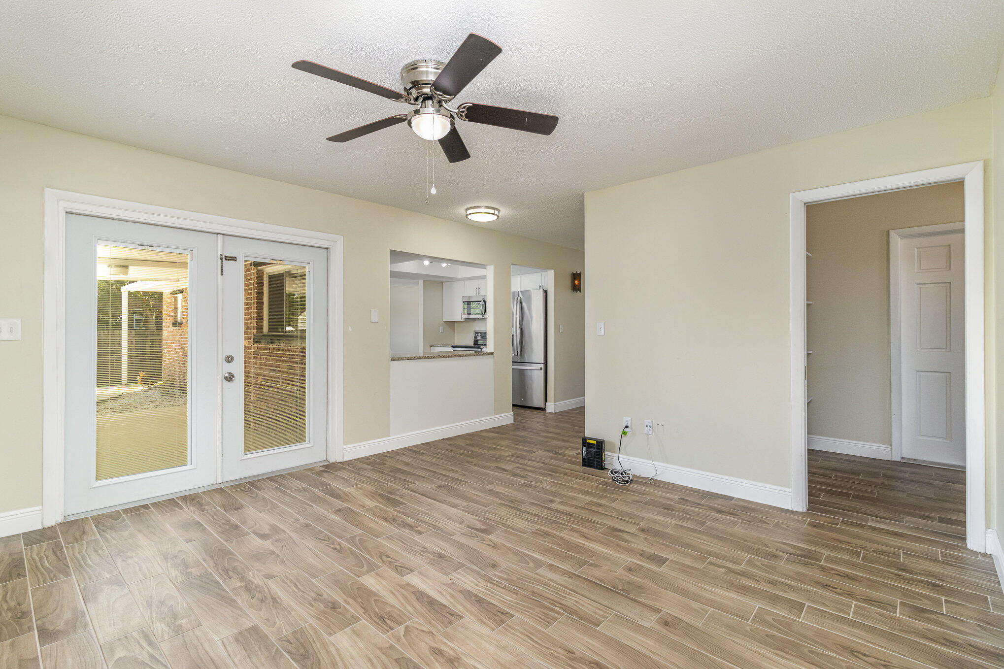 1294 Cimarron Circle Northeast Palm Bay, FL 32905 - Photo 14 of 45 a view of a livingroom with wooden floor and a ceiling fan