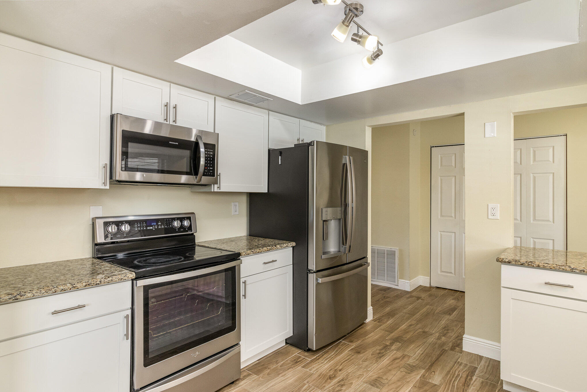 1294 Cimarron Circle Northeast Palm Bay, FL 32905 - Photo 15 of 45 a kitchen with a refrigerator stove and microwave