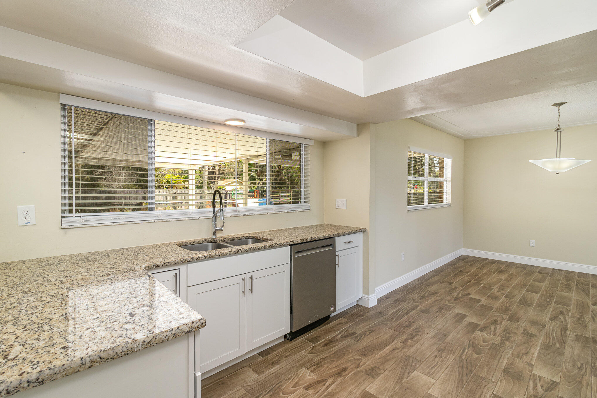 1294 Cimarron Circle Northeast Palm Bay, FL 32905 - Photo 16 of 45 a kitchen with granite countertop sink and window