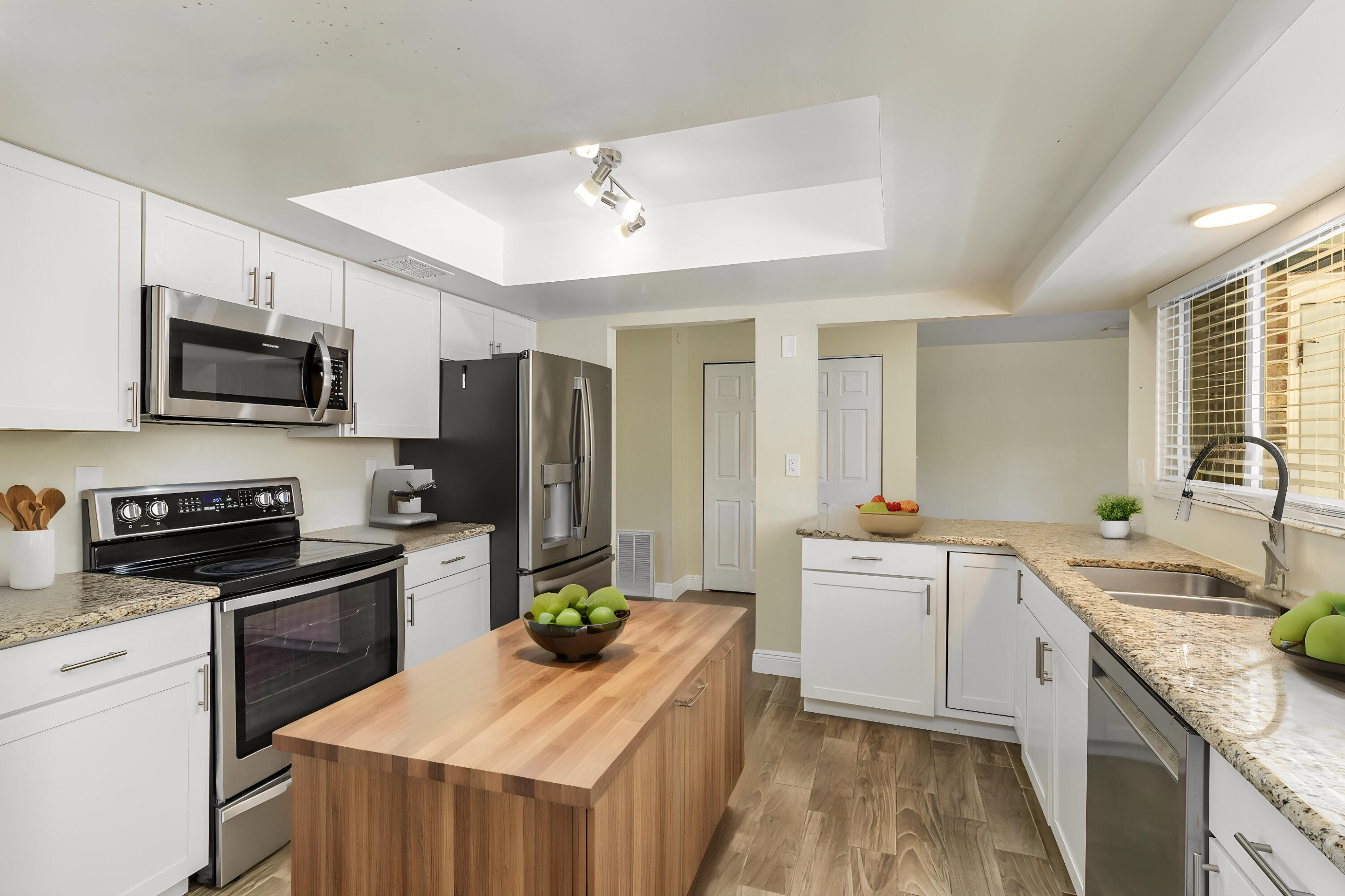 1294 Cimarron Circle Northeast Palm Bay, FL 32905 - Photo 18 of 45 a kitchen with a sink a counter top space stainless steel appliances and cabinets