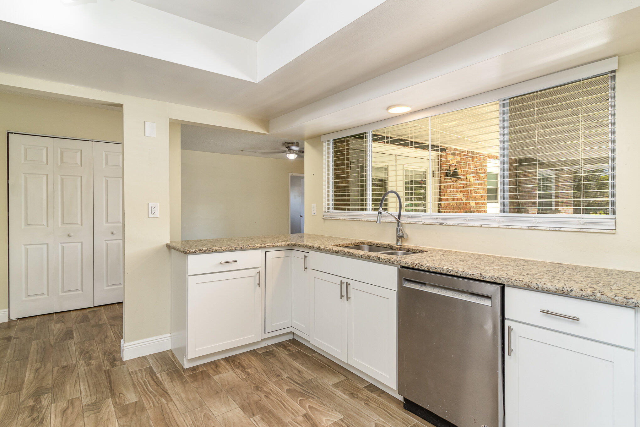 1294 Cimarron Circle Northeast Palm Bay, FL 32905 - Photo 19 of 45 a spacious bathroom with a granite countertop sink and dishwasher next to a window