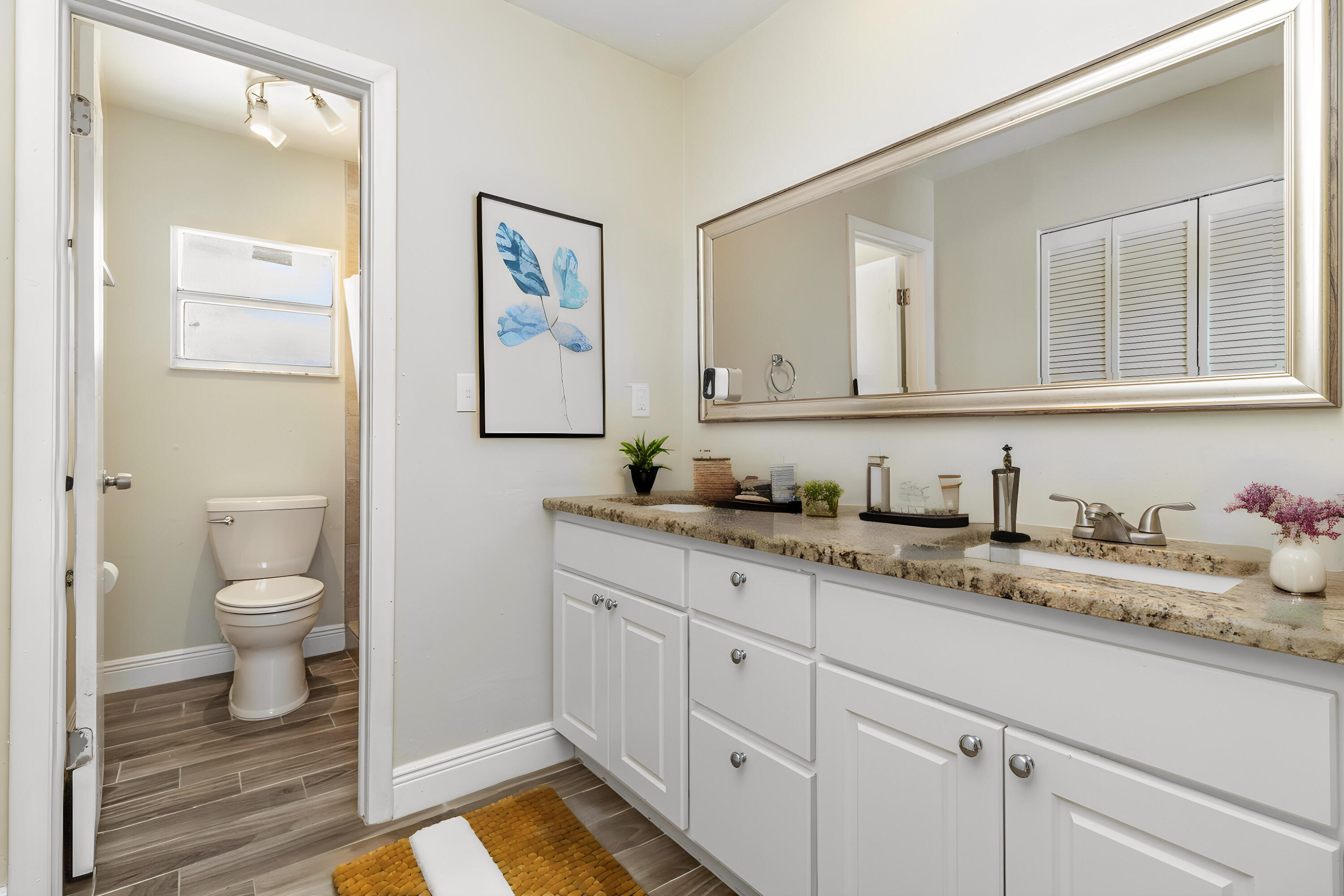 1294 Cimarron Circle Northeast Palm Bay, FL 32905 - Photo 24 of 45 a bathroom with a granite countertop sink and a toilet
