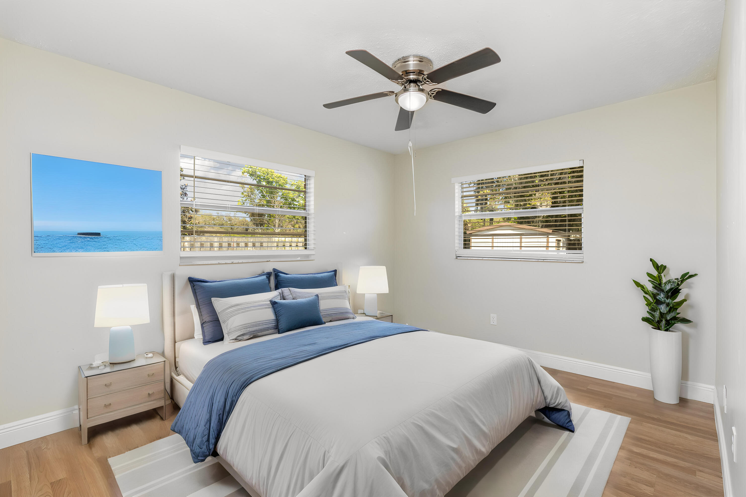 1294 Cimarron Circle Northeast Palm Bay, FL 32905 - Photo 28 of 45 a bedroom with a large bed and a chandelier