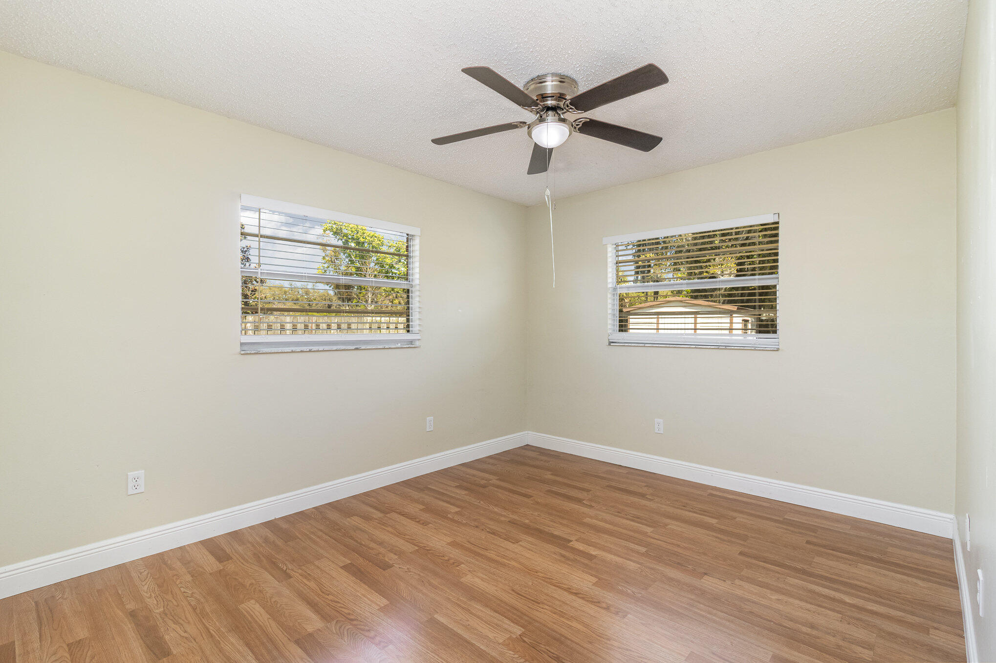 1294 Cimarron Circle Northeast Palm Bay, FL 32905 - Photo 29 of 45 a view of a big room with wooden floor and windows