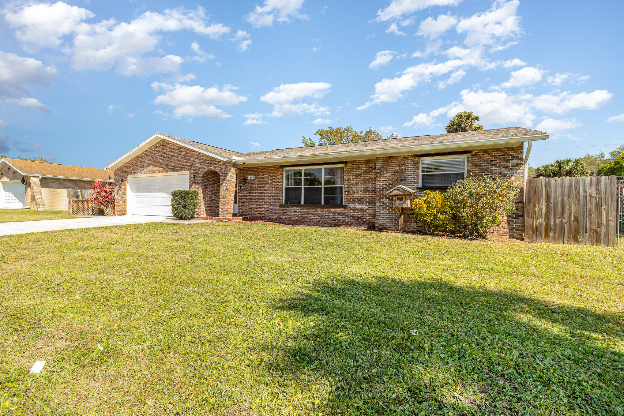 1294 Cimarron Circle Northeast Palm Bay, FL 32905 - Photo 3 of 45 a front view of house with yard and green space