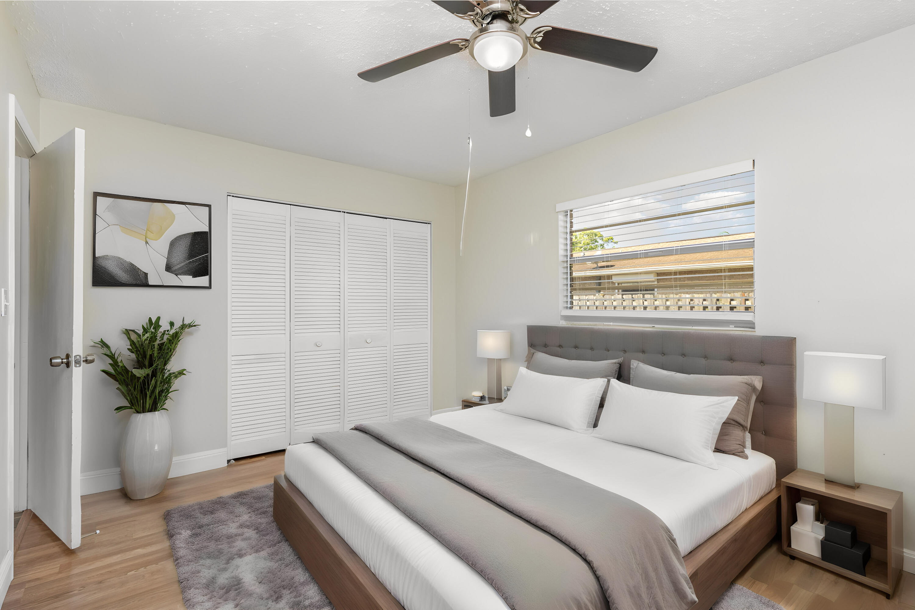 1294 Cimarron Circle Northeast Palm Bay, FL 32905 - Photo 32 of 45 a bedroom with a bed and a potted plant