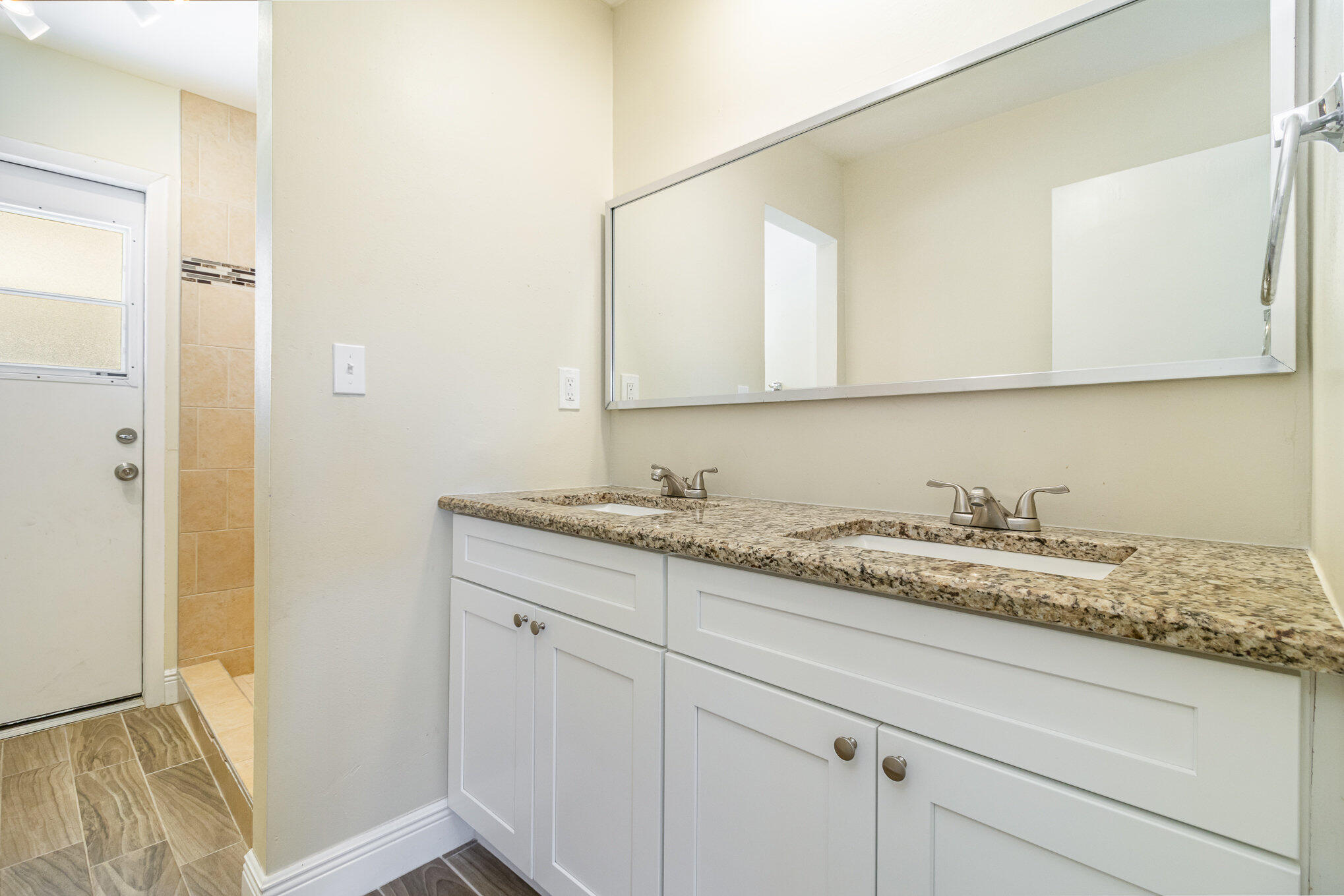 1294 Cimarron Circle Northeast Palm Bay, FL 32905 - Photo 33 of 45 a bathroom with a granite countertop sink and a mirror