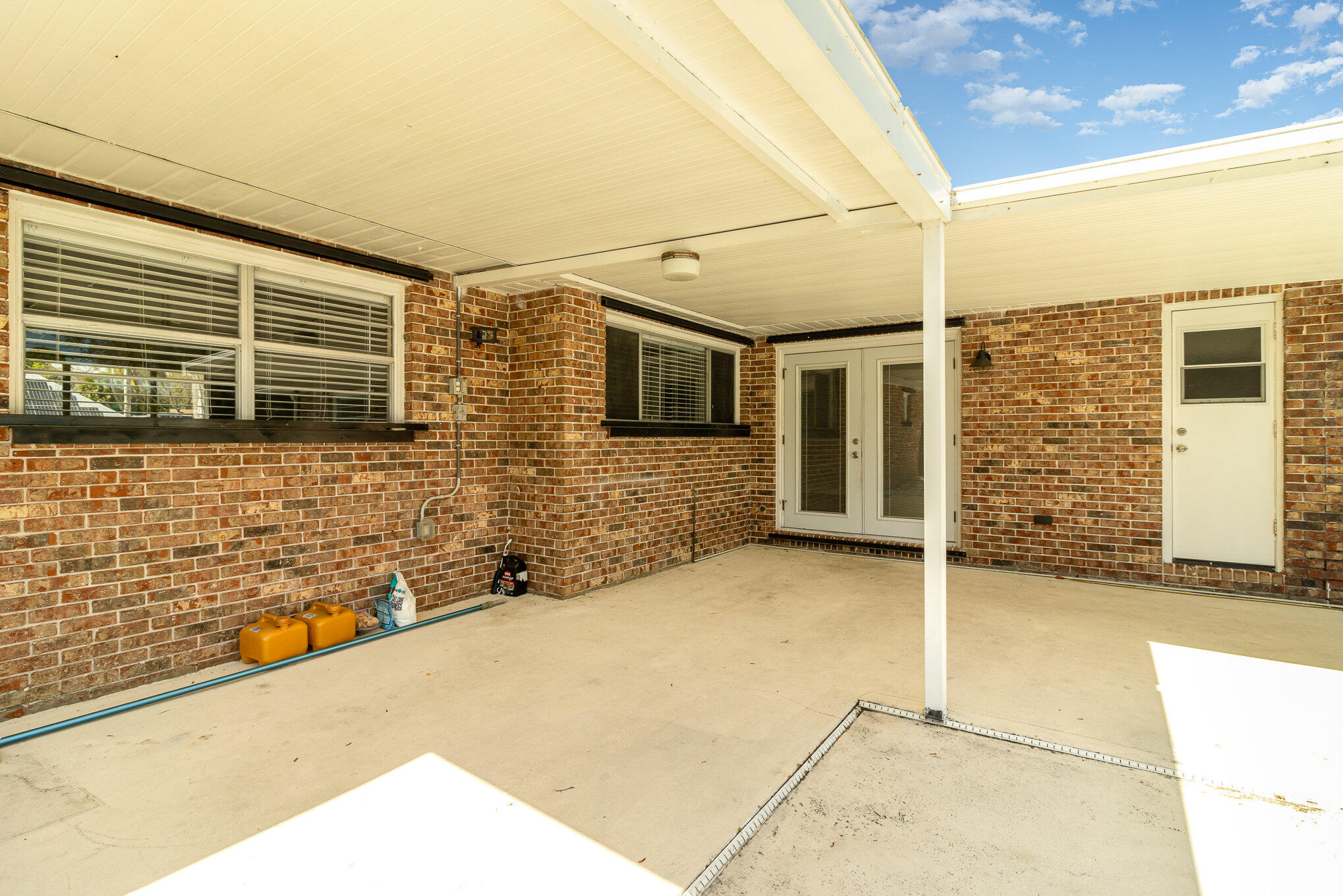 1294 Cimarron Circle Northeast Palm Bay, FL 32905 - Photo 40 of 45 a view of a wooden house with large windows