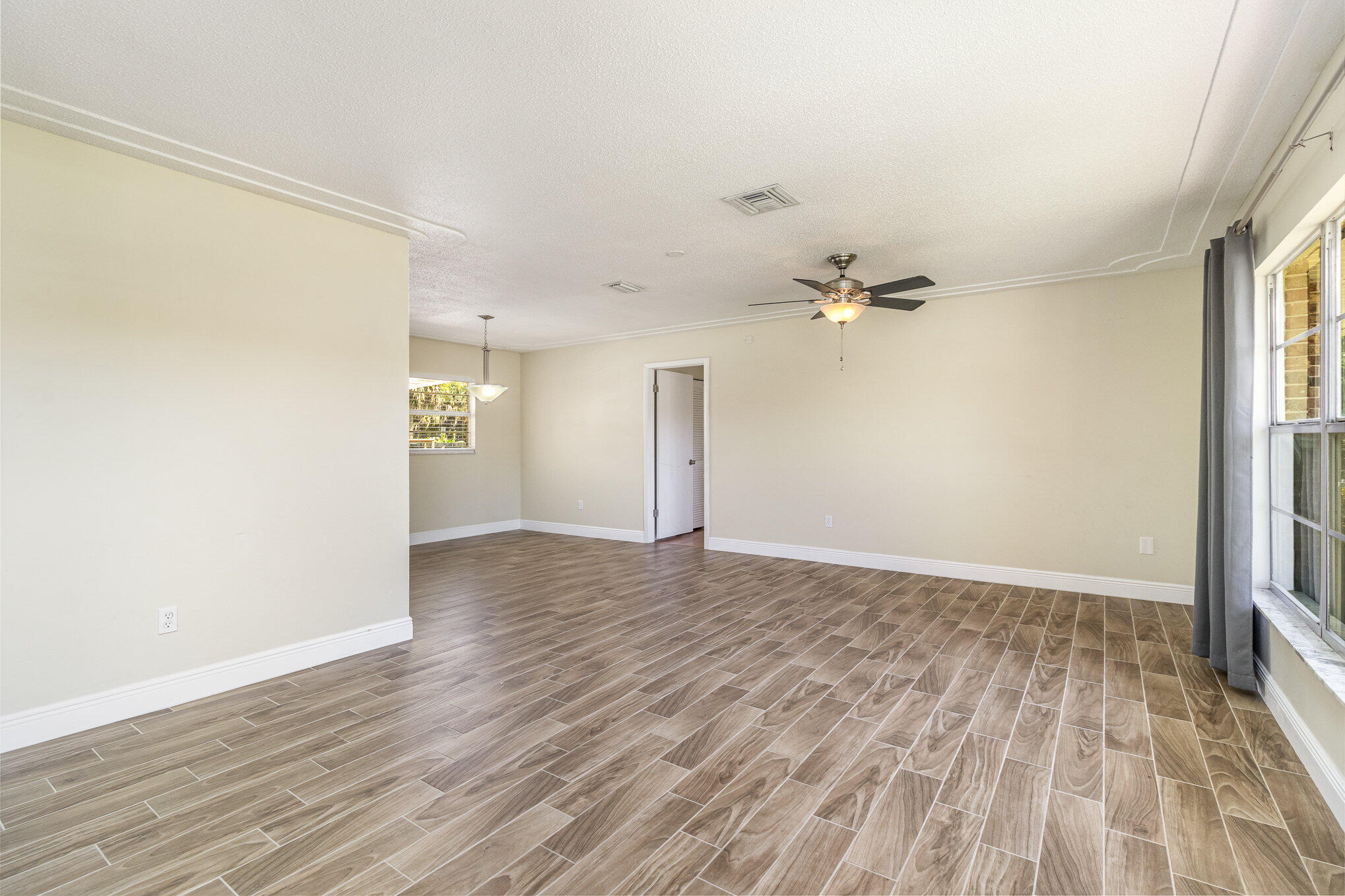 1294 Cimarron Circle Northeast Palm Bay, FL 32905 - Photo 4 of 45 wooden floor in an empty room with a window