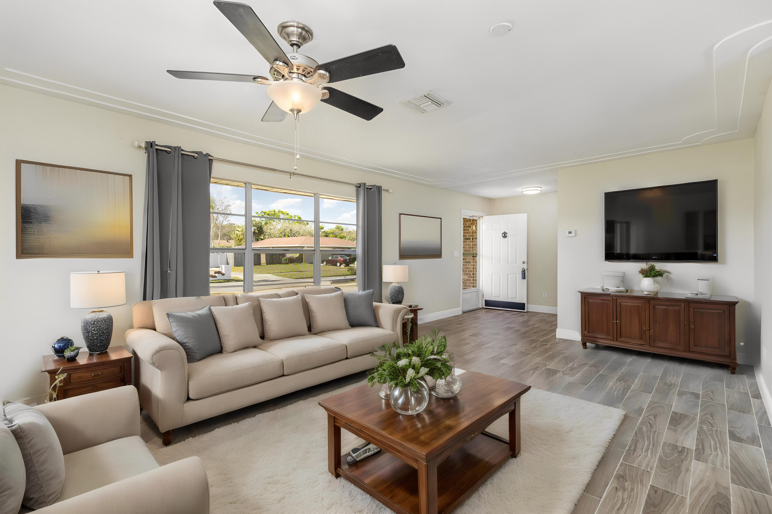1294 Cimarron Circle Northeast Palm Bay, FL 32905 - Photo 6 of 45 a living room with furniture and a flat screen tv