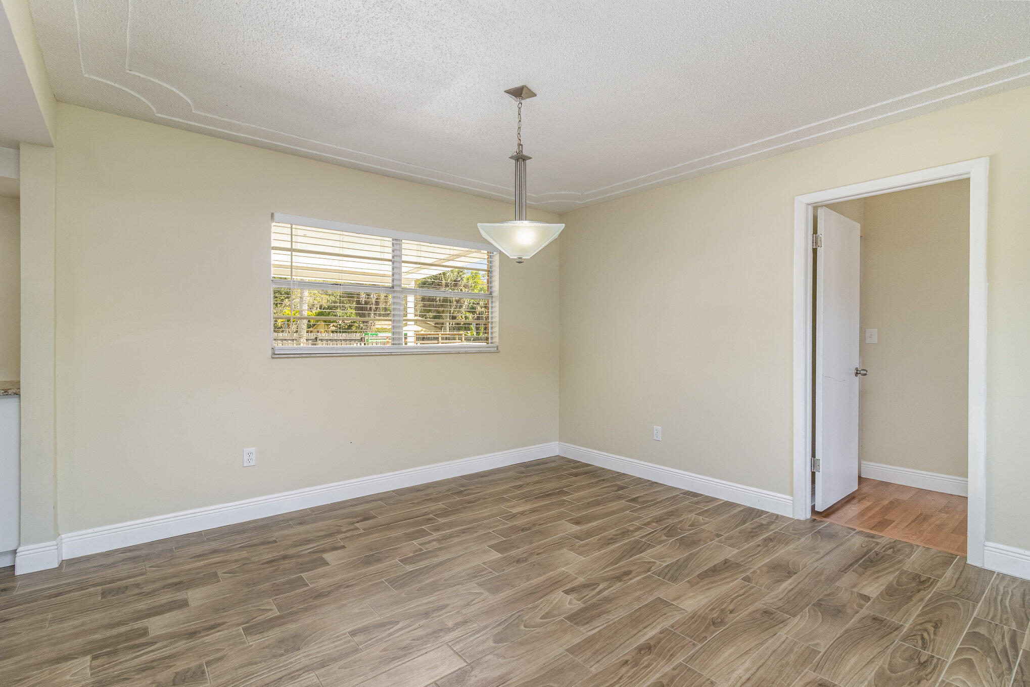 1294 Cimarron Circle Northeast Palm Bay, FL 32905 - Photo 9 of 45 a view of a room window and wooden floor