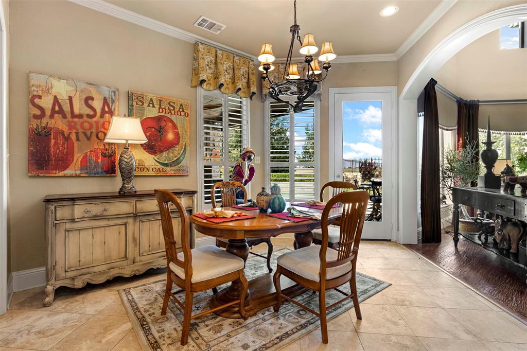 801 White Buffalo Lane Heath, TX 75032 - Photo 19 of 39 a view of a dining room with furniture a chandelier and window