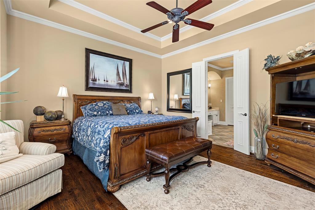 801 White Buffalo Lane Heath, TX 75032 - Photo 24 of 39 a bedroom with a bed and wooden floor