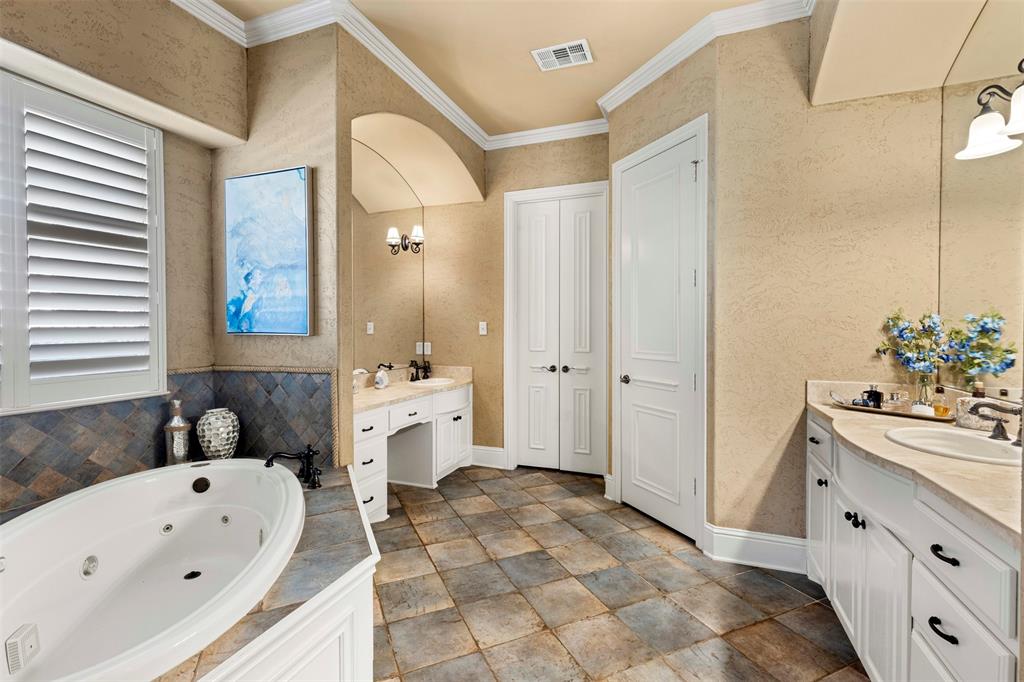 801 White Buffalo Lane Heath, TX 75032 - Photo 25 of 39 a bathroom with a sink mirror and a bathtub