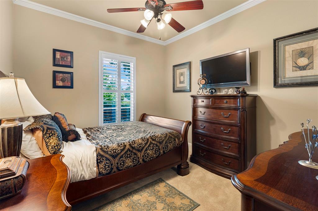 801 White Buffalo Lane Heath, TX 75032 - Photo 27 of 39 a bedroom with a bed and a flat screen tv