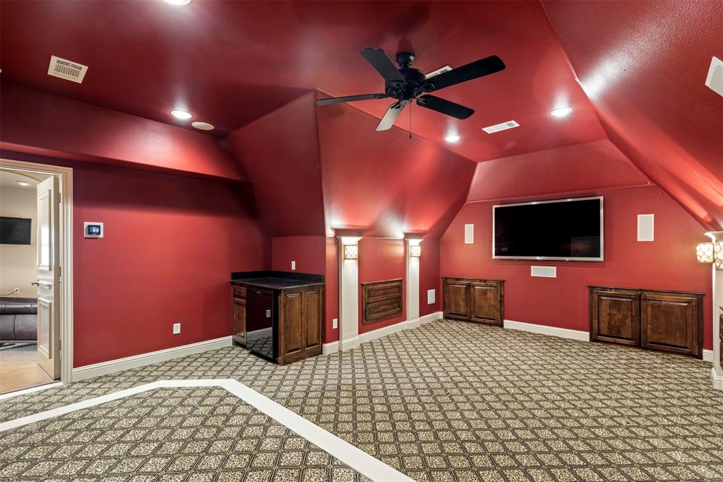 801 White Buffalo Lane Heath, TX 75032 - Photo 30 of 39 a bedroom with a bed and a flat screen tv