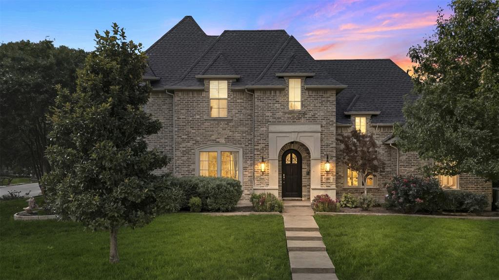 801 White Buffalo Lane Heath, TX 75032 - Photo 34 of 39 a front view of a house with a garden
