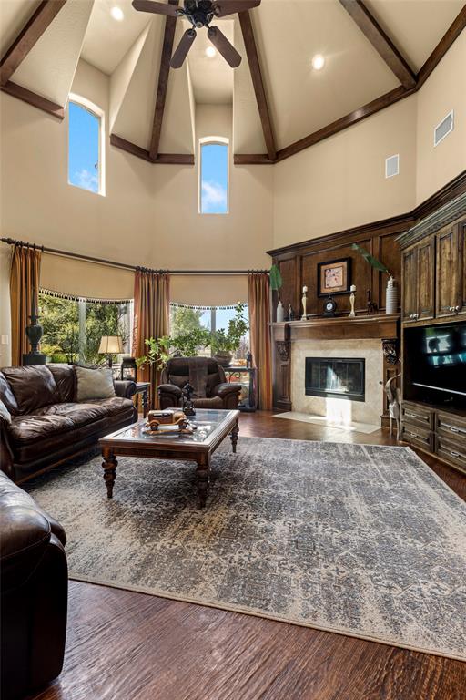801 White Buffalo Lane Heath, TX 75032 - Photo 38 of 39 a living room with furniture a fireplace and a flat screen tv