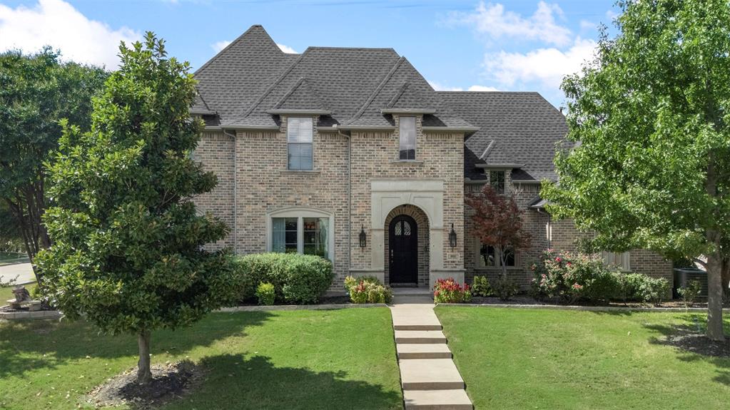 801 White Buffalo Lane Heath, TX 75032 - Photo 6 of 39 a front view of a house with a garden and plants