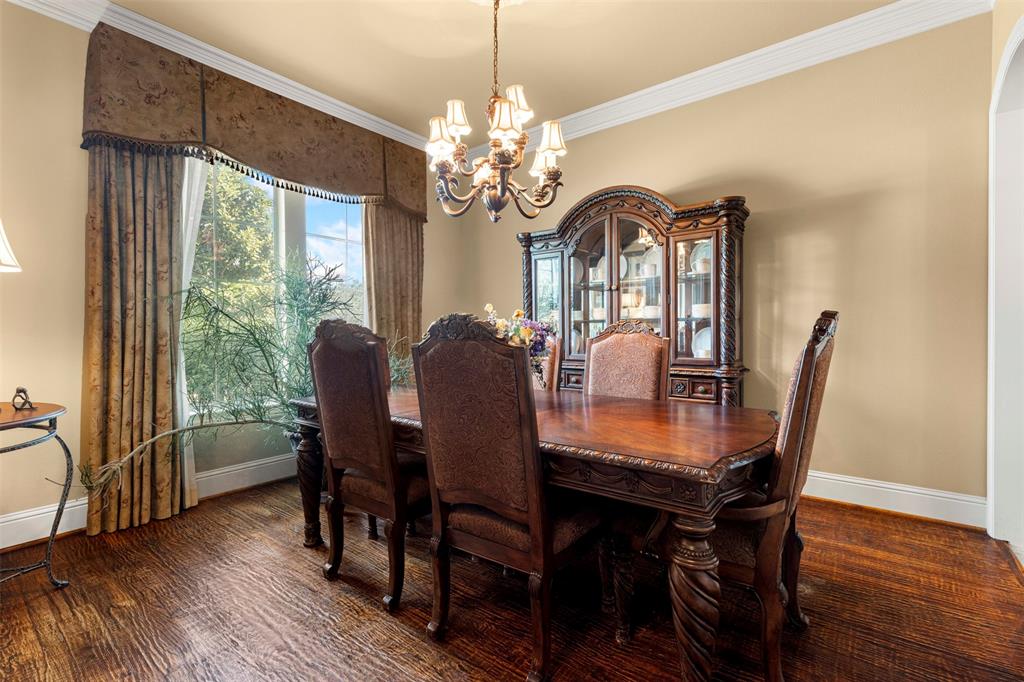 801 White Buffalo Lane Heath, TX 75032 - Photo 9 of 39 a view of a dining room with furniture window and wooden floor