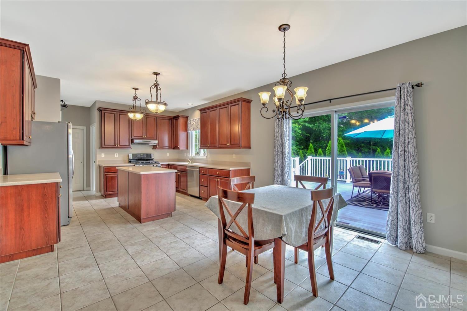 32 Spruce Meadows Drive Monroe Township, NJ 08831 - Photo 11 of 46 a view of a dining room with furniture a chandelier and window