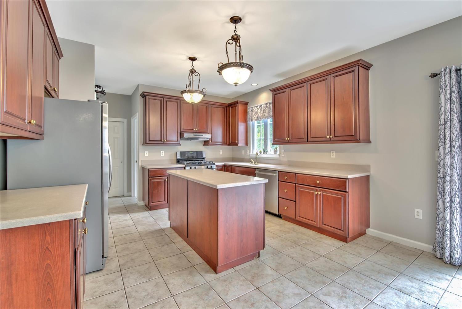 32 Spruce Meadows Drive Monroe Township, NJ 08831 - Photo 13 of 46 a kitchen with granite countertop wooden cabinets and a stainless steel appliances