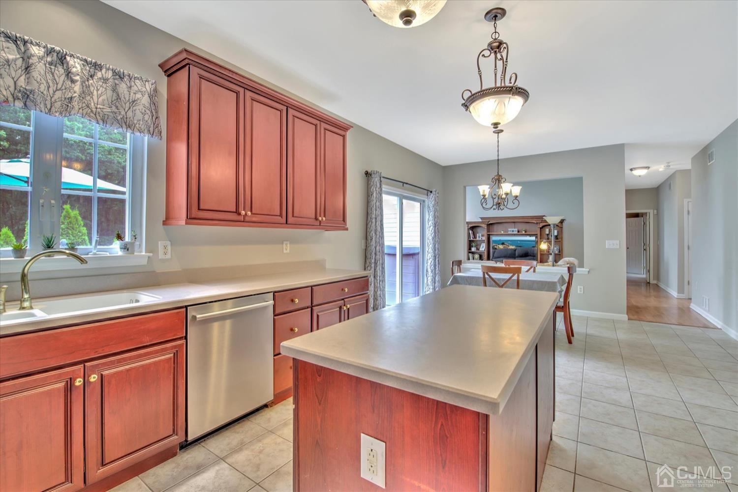 32 Spruce Meadows Drive Monroe Township, NJ 08831 - Photo 15 of 46 a kitchen with kitchen island granite countertop a sink cabinets and stainless steel appliances