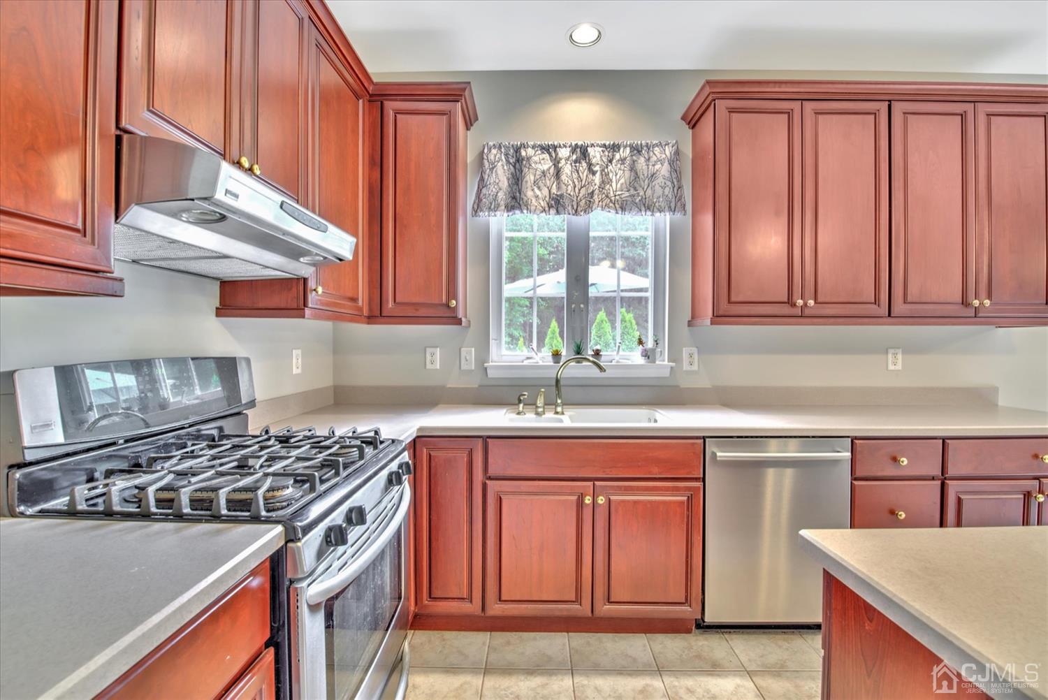 32 Spruce Meadows Drive Monroe Township, NJ 08831 - Photo 16 of 46 a kitchen with a sink stove top oven and cabinets