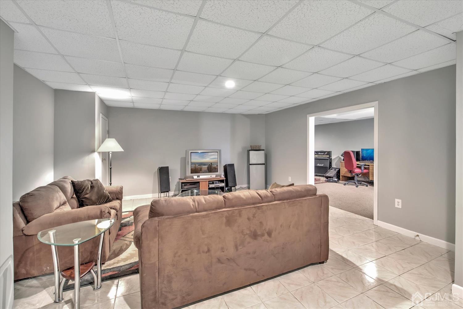 32 Spruce Meadows Drive Monroe Township, NJ 08831 - Photo 34 of 46 a living room with furniture and a flat screen tv