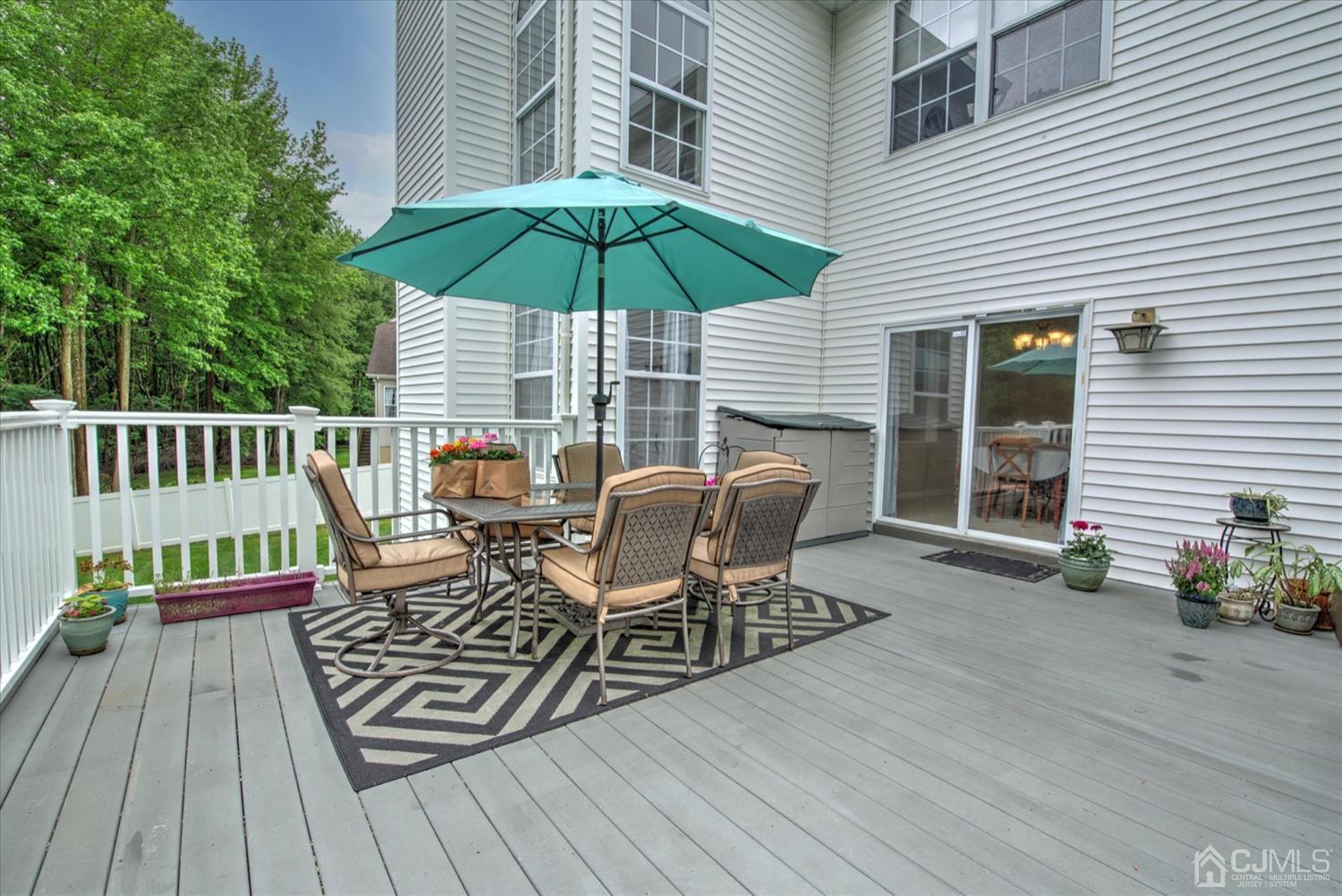 32 Spruce Meadows Drive Monroe Township, NJ 08831 - Photo 41 of 46 an outdoor space with furniture and umbrella