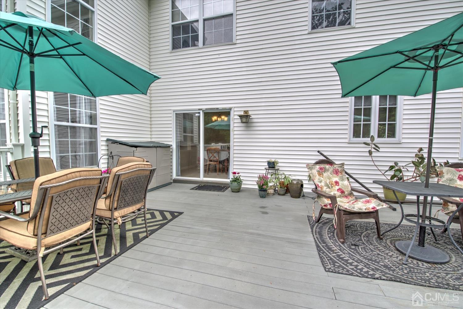 32 Spruce Meadows Drive Monroe Township, NJ 08831 - Photo 43 of 46 a patio with a table and chairs under an umbrella