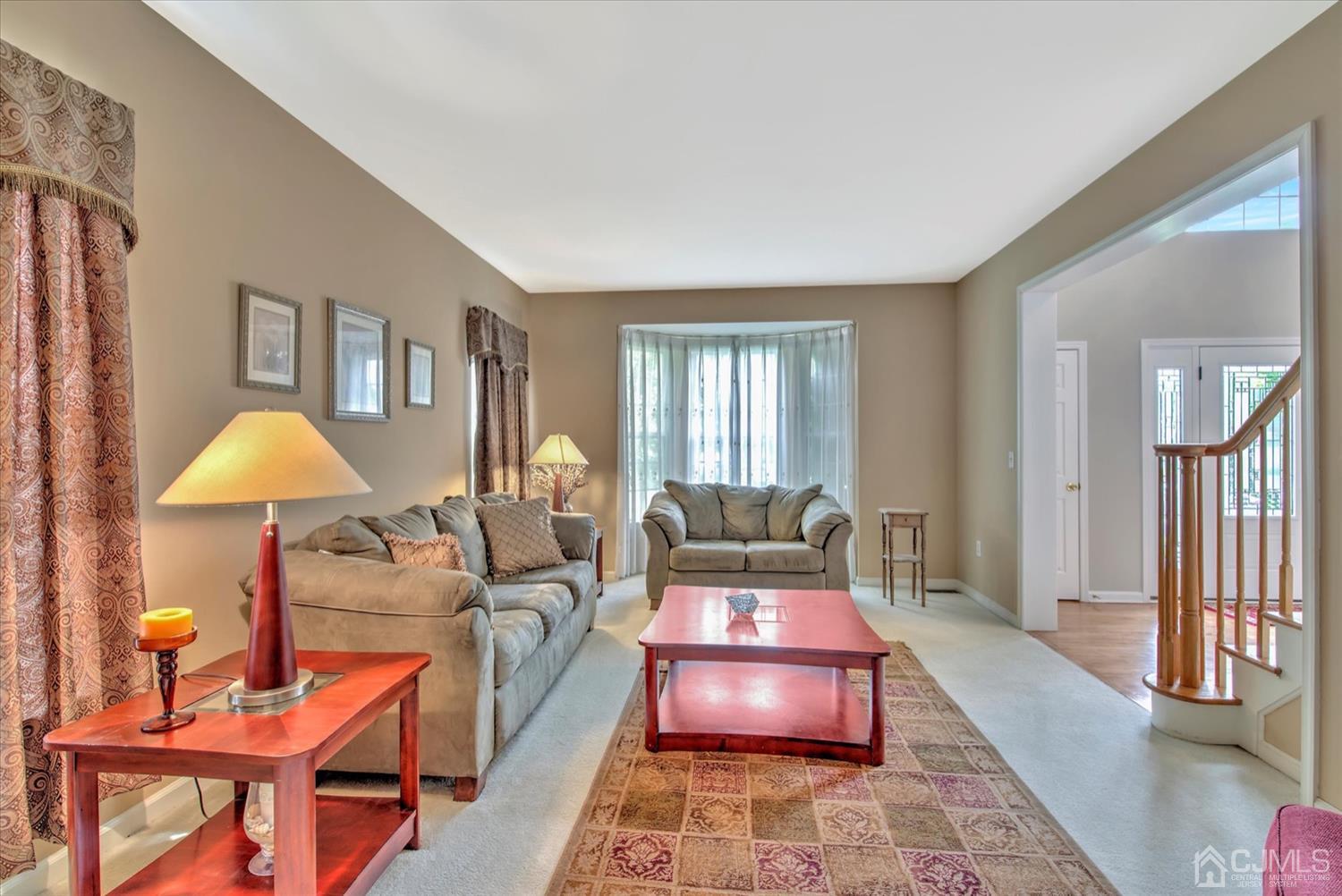 32 Spruce Meadows Drive Monroe Township, NJ 08831 - Photo 6 of 46 a living room with furniture and a lamp