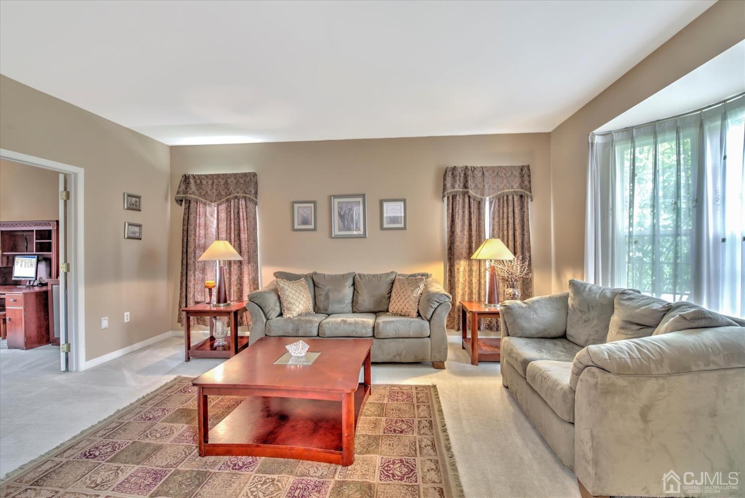 32 Spruce Meadows Drive Monroe Township, NJ 08831 - Photo 7 of 46 a living room with furniture and a large window