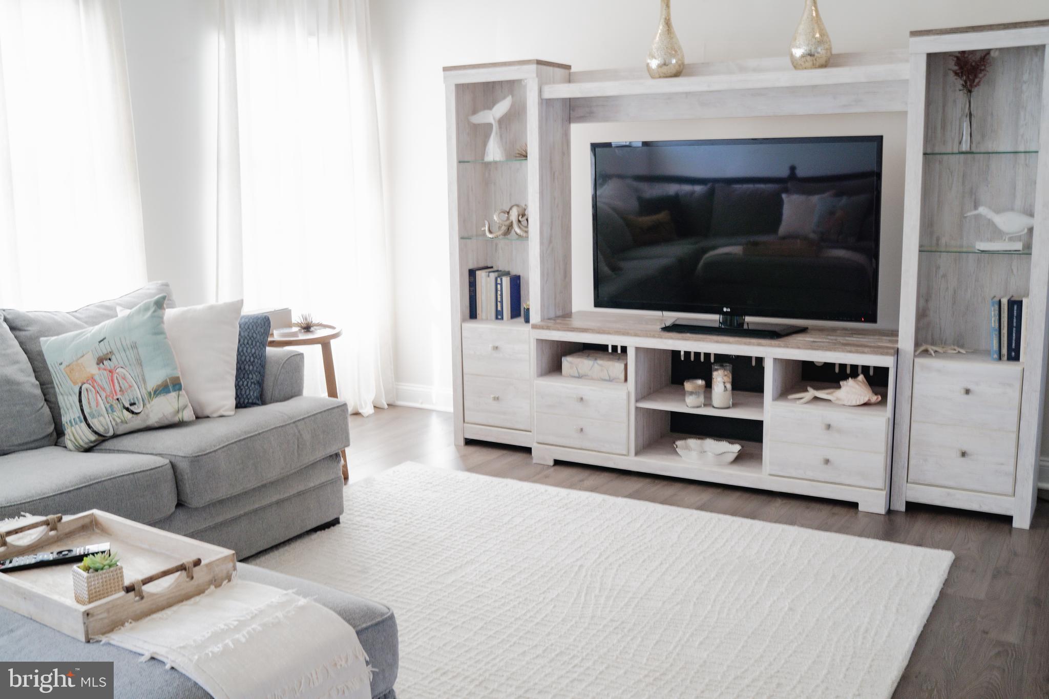 36046 Auburn Way Millsboro, DE 19966 - Photo 12 of 56 a living room with furniture and a flat screen tv