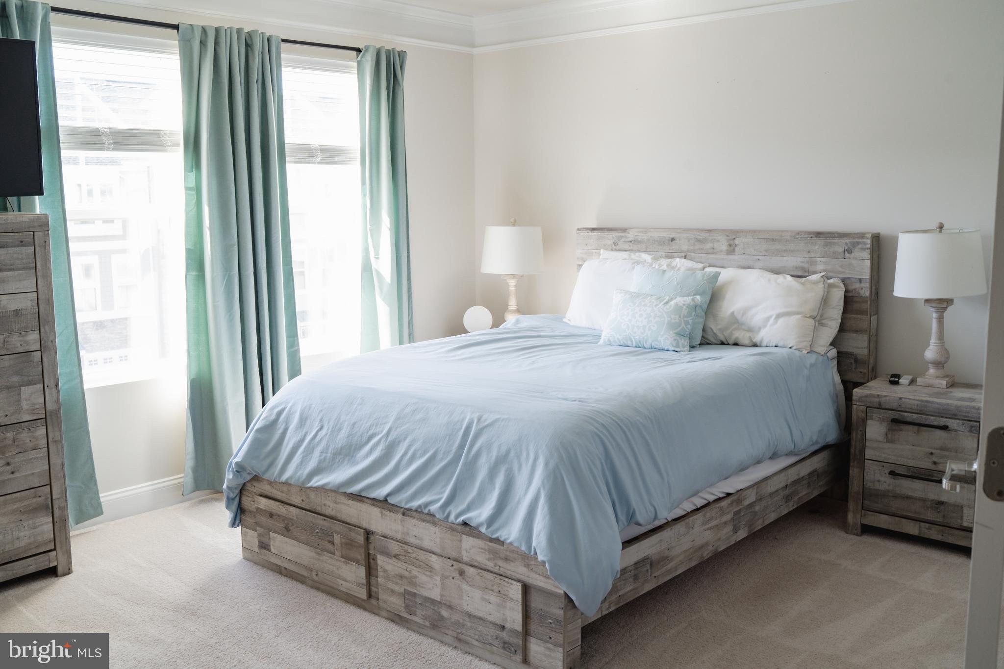 36046 Auburn Way Millsboro, DE 19966 - Photo 30 of 56 a bed sitting in a bedroom next to a window