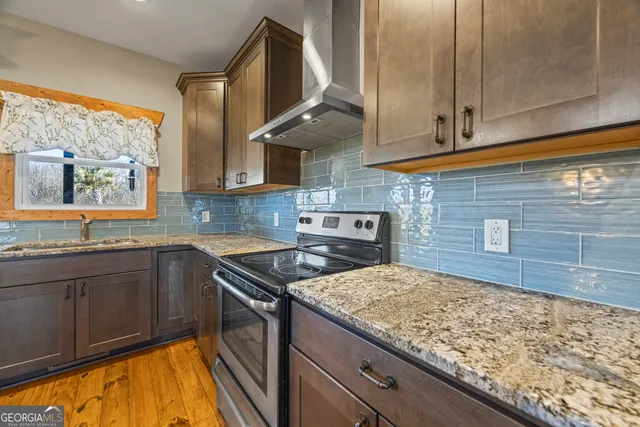 a bathroom with a granite countertop sink a mirror and a shower