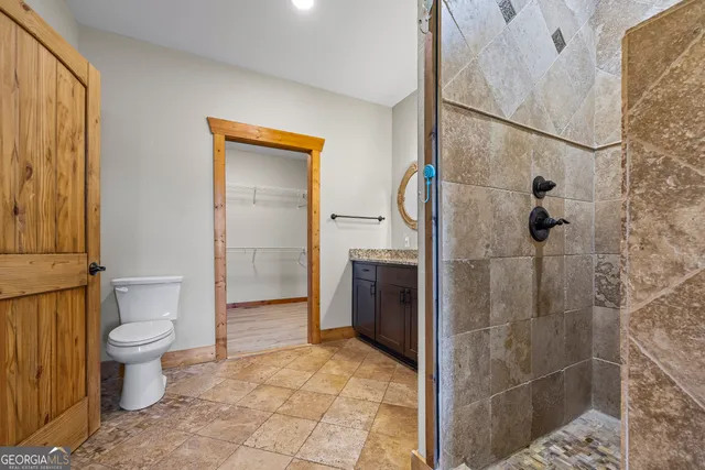 a bathroom with a toilet a sink and shower