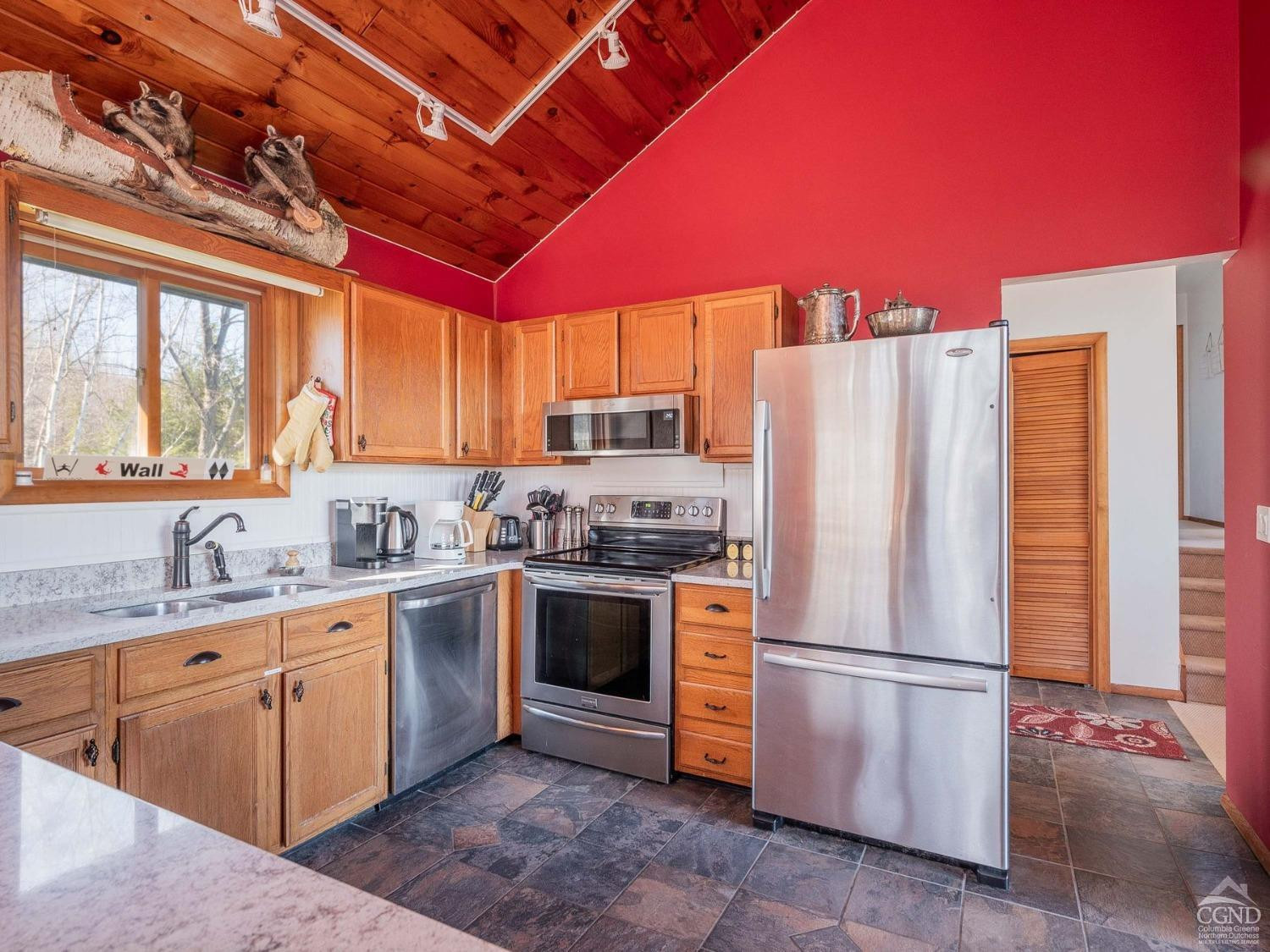 266 Siam Road Windham, NY 12496 - Photo 8 of 52 a kitchen with stainless steel appliances granite countertop a refrigerator a sink dishwasher a stove with white countertops and cabinets