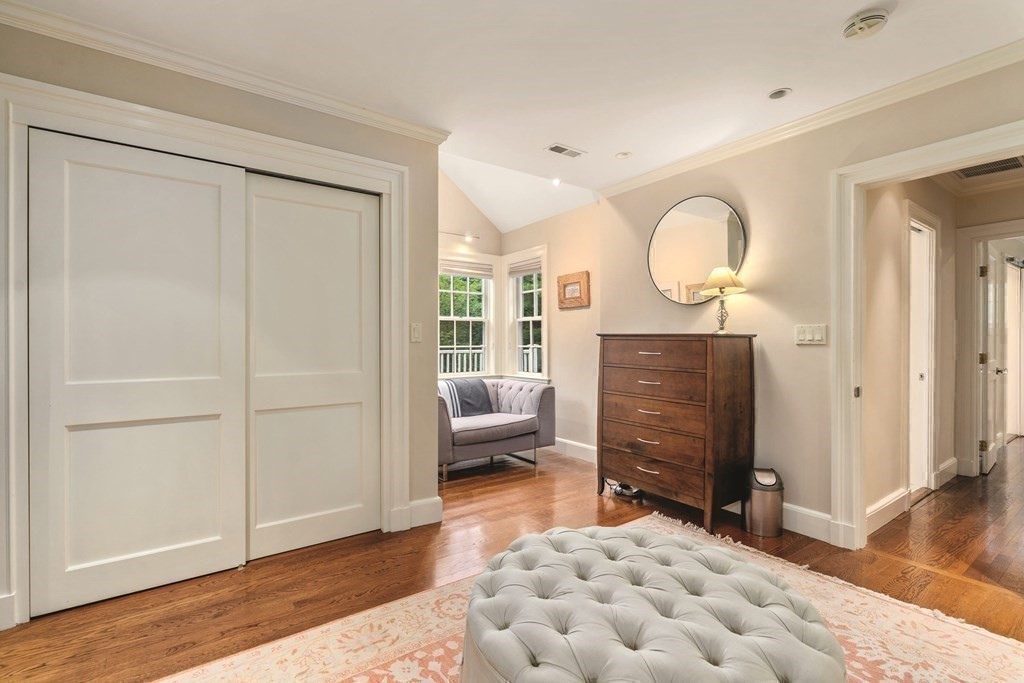 131 Oliver Road Newton, MA 02468 - Photo 25 of 41 a bedroom with a bed and wooden floor