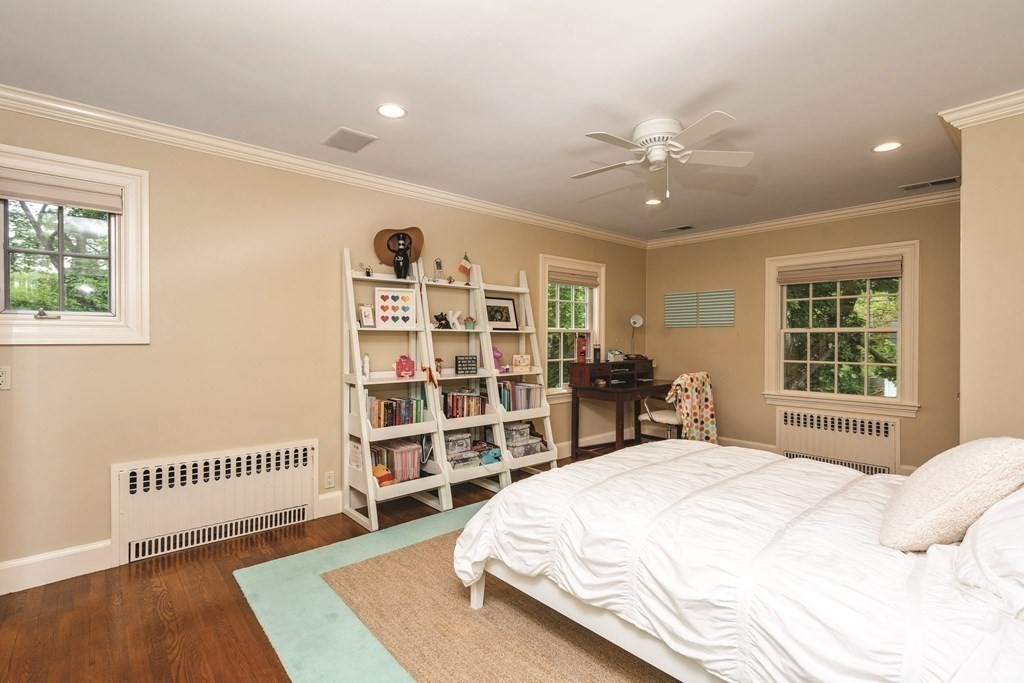 131 Oliver Road Newton, MA 02468 - Photo 26 of 41 a spacious bedroom with a bed a dresser and a large window