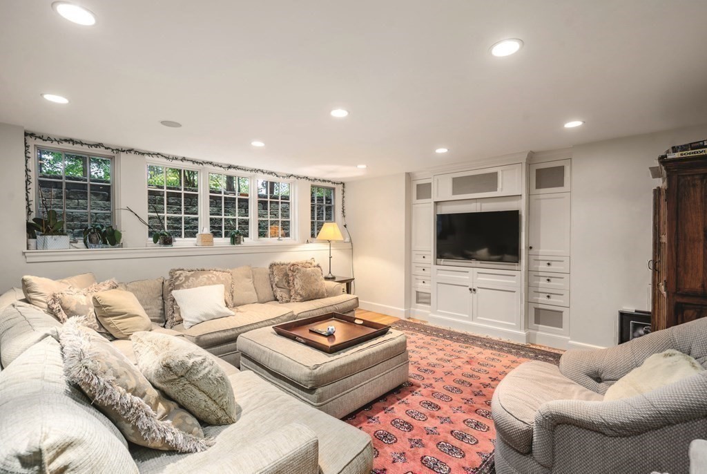 131 Oliver Road Newton, MA 02468 - Photo 33 of 41 a living room with furniture and a flat screen tv